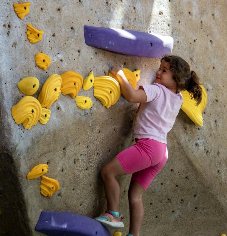 Kid climbing on rock wall